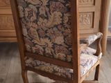 a chair that is sitting in front of a dresser