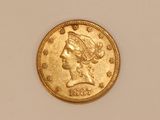 a close up of a gold coin on a white surface