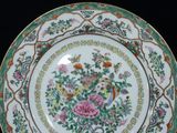 a plate with a floral design on it on a black surface
