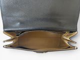 the inside of a black leather purse with gold zippers