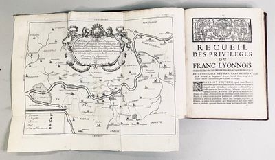 an open book with a map of france on it sitting on top of a table