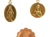 three gold medals hanging from a string on a white background