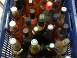 many bottles of beer in a blue basket