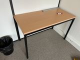 a wooden desk with a black metal frame and a black trash can