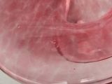 a close up of a pink object on a table