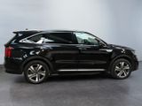 a black suv parked in a garage with a white wall
