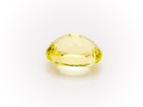 a yellow sapphire stone on a white background