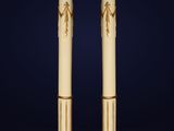 a pair of gold and white columns with an egyptian design
