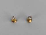 a pair of gold and diamond stud earrings