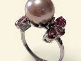 an image of a ring with a pearl and pink stones on it