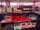 bottles of wine and bottles of beer on a shelf in a store