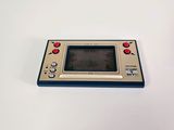 an old game console sitting on top of a white table