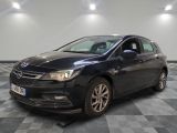 a black car is parked in a room with a checkered floor