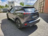 the rear end of a silver suv parked in a parking lot