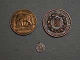 two coins are shown next to each other on a table
