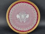a picture of a pink and white plate with a crown on it