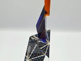 a sculpture made out of a piece of glass on a white surface