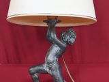 an image of a lamp with a boy holding a rope