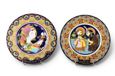 two decorative plates with a painting of a woman and a man
