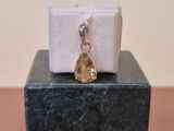 a small piece of jewelry sitting on top of a box