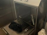 a black bag sitting on top of a stove in a kitchen