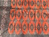 an orange and black area rug with a pattern on it