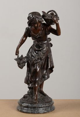 bronze statue of a woman holding a basket of flowers on a table
