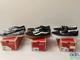 three pairs of vans shoes are sitting on top of boxes