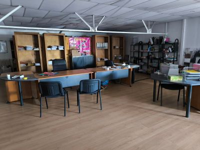 une pièce avec un bureau, des chaises et des bibliothèques