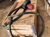 a pile of wooden pallets and a hose on the ground