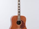 a close up of an acoustic guitar on a white background