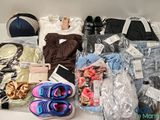 a lot of clothing and shoes that are on a table