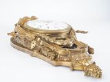 a gold clock sitting on top of a table