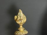 a vase with a flower on top of it on a table