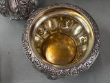 a silver bowl sitting on top of a table