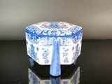 a small blue and white box on a black table