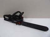 a black and red chainsaw sitting on top of a white table