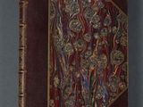 an old book with a decorative design on the cover