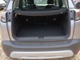 the back of a car with its trunk open in a parking lot