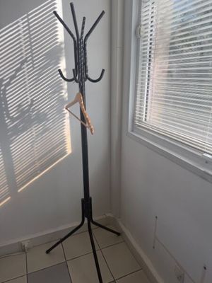 an image of a coat rack in the corner of a room