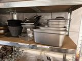 many pans and pans on the shelves in the kitchen