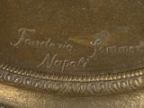 a close up of a bronze plate with writing on it