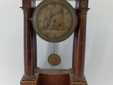 a wooden clock that is sitting on a table