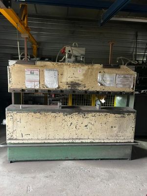 a large machine is sitting in a warehouse with a lot of boxes