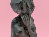 an image of a statue of a woman with a hat on her head