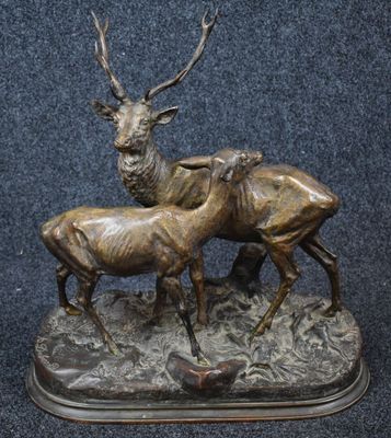 bronze sculpture of a stag and a baby stag on a base