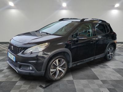 la voiture noire est garée sur un sol en damier dans le garage