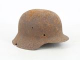 an old rusty helmet on a white surface with a white background