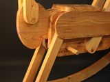 wooden rocking horse on a black background with a black background