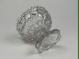 a glass ball with a lid sitting on a table